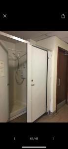 a bathroom with a shower and a glass door at Eco Crofter's Wagon by the Sea - Off Grid Experience - No electricity - As seen soon on Netflix in Oldshoremore