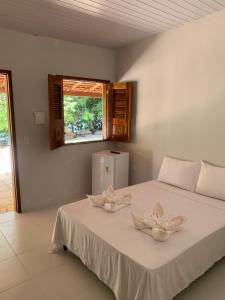a bedroom with a bed with two bowls on it at POUSADA PARAÍSO CULTURAL in Barreirinhas