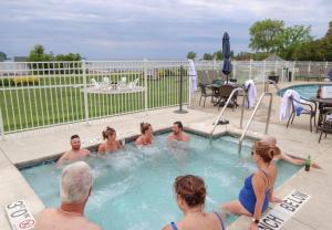 a group of people sitting in a swimming pool at The Water Street Inn in Ephraim