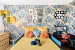 a small bedroom with a bed with a desk at Paris Family & Friends - Gare à 5 Minutes - Parking in Le Bourget