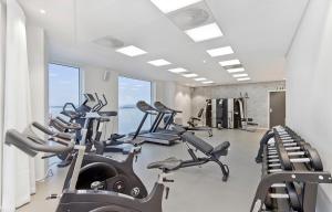 a gym with several treadmills and cardio machines at ONS 2024 apartment for rent - panoramic view, private gym,parking - close to city centre in Stavanger