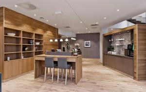 a lobby with a bar with chairs and a kitchen at ONS 2024 apartment for rent - panoramic view, private gym,parking - close to city centre in Stavanger