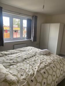a bedroom with a bed with a white comforter at Mesnes Place in Wigan