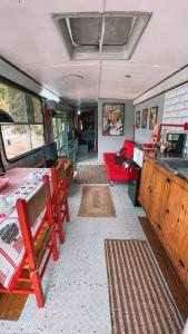 a living room with tables and chairs in an rv at Hospedagem Ônibus na Roça em Serra ES in Serra