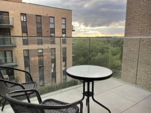 a table and chairs on a balcony with a view at Godfrey house, Edinburgh way Harlow in Harlow