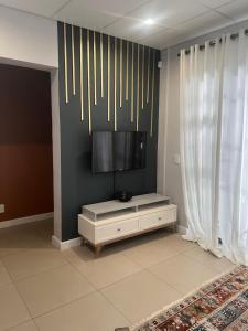 a living room with a tv on a wall at Finagaello at Amfeld apartment by MGP in Windhoek