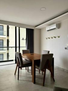 a dining room with a wooden table and chairs at AC Andares Tec Nespresso Estacionamiento Gratis 4p in Guadalajara