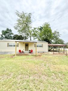 a house with a large yard in front of it at Route 66 Pop Stop-Minutes to Main St in Bandera