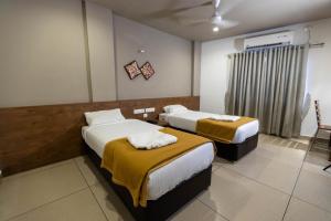 Aryaas Residency Nettoor客房内的一张或多张床位