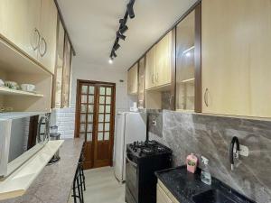a kitchen with a stove and a refrigerator at PHX_812 - Apartamento 2 quartos 7 hospedes in Guarulhos