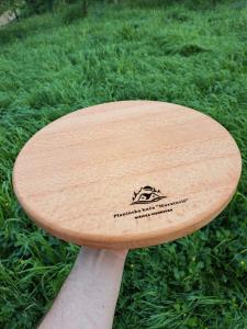 a wooden surfboard sitting on top of the grass at Planinska Kuća Nišićka Visoravan in Sarajevo