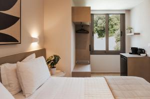 A bed or beds in a room at Ariadne Suites