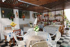 a restaurant with tables and chairs with flowers on them at Hostal Bahía, habitaciones en pleno centro y a pasos de la playa in Iquique