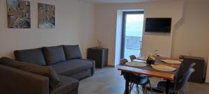 a living room with a couch and a table at Apartment Desanti 2 Valun in Valun