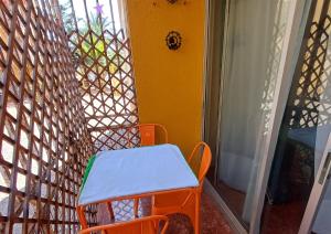 a orange chair sitting on a porch next to a window at depa playa in Arica