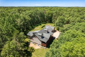 an overhead view of a large house in the woods at Dog-friendly 6-acre 5BR 3BA home, game room, deck, Wisconsin Dells 10min in Lyndon Station
