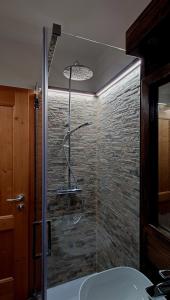a bathroom with a shower and a sink at Bilocale centro paese con posto auto in Madonna di Campiglio +23 photos