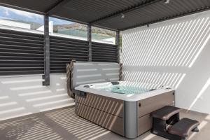 a hot tub on the balcony of a house at Villa AG in Podstrana