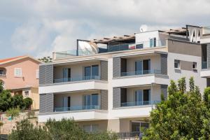 an apartment building with a glass facade at Villa AG in Podstrana