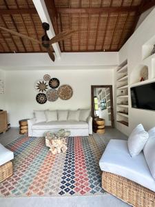 a living room with two beds and a rug at Santai Villas in Nusa Lembongan