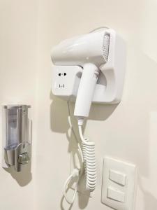 a white phone is attached to a wall at Comodidad y confort en casa Arennas in Mérida