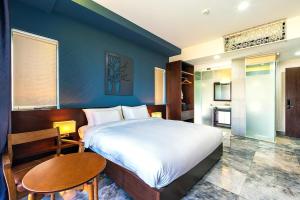 una camera da letto con un letto grande e un tavolo di MOJO Boutique HOTEL a Phu Quoc