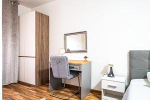 a bedroom with a desk and a bed and a mirror at Villa Leny with pool in Sukošan
