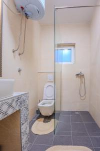 a bathroom with a toilet and a glass shower at Villa Leny with pool in Sukošan