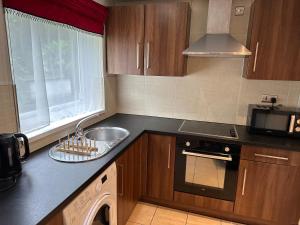 a kitchen with a sink and a counter top at Entire studio flat in Manchester