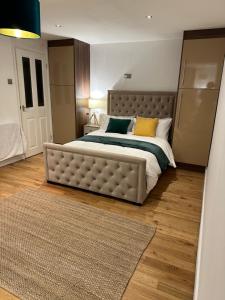a bedroom with a large bed with yellow pillows at Entire studio flat in Manchester