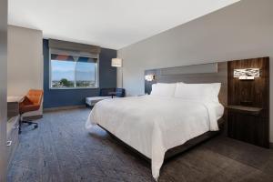a bedroom with a large white bed and a window at Holiday Inn Express & Suites Ontario - Chino Hills by IHG in Chino Hills