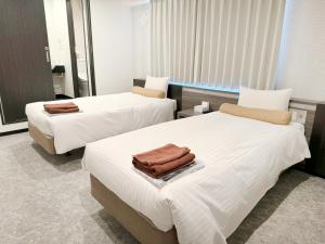 Postel nebo postele na pokoji v ubytování RE Hotel 梅田