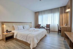 Postel nebo postele na pokoji v ubytování Le President Hotel