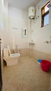 a bathroom with a toilet and a sink at Green View Luxury Apartments in Varanasi