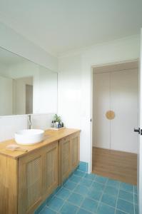 a bathroom with a sink and a mirror at Blueholes Beach Villa - Private Outdoor Space in Kalbarri