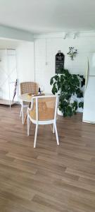 a room with a table and chairs and a plant at The Glade, peace among the trees on the river in Urunga