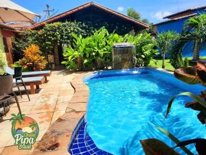 a swimming pool in the middle of a yard at Chalés Pipa Brasil in Pipa