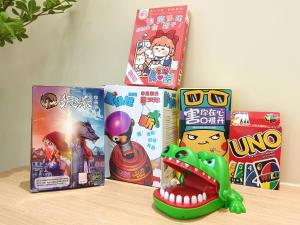 a table with boxes of games and a toy at Ayera Residence Muji X Near Permas X Staycation 4BR4B #12 pax by Cowidea in Masai