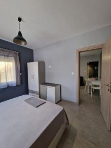 a bedroom with a large bed and a table at BRAND NEW 90m from the SEA 50m2 in Agia Triada