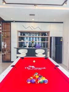 a red pool table with balls on top of it at The Present Samed pool villa in Ko Samed