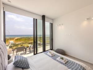 a bedroom with a bed and a view of the ocean at Villa Pliades in Ayia Napa +285 photos