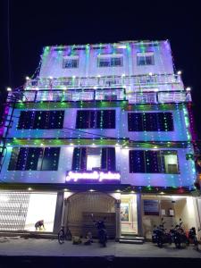 a lit up building with christmas lights on it at Jagannath Palace in mayapur