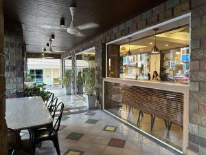 a restaurant with a table and chairs and a counter at Link Mansion in Chiang Mai