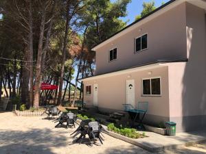 un grupo de sillas sentadas fuera de un edificio en Vila Topi, en Vlorë