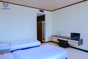Bandung Permai Hotel Jember客房内的一张或多张床位