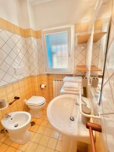 a bathroom with a sink and a toilet at Casa Romano in Fiumicino