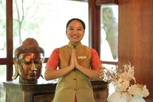 a woman is performing a meditation gesture in a room at The Tree House Resort, A Club Mahindra Associate in Jaipur +74 photos