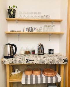 a counter with plates and glasses on a shelf at Boutique hotel mestia in Mestia