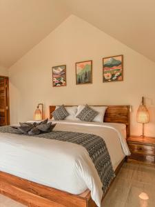a bedroom with a large bed with two lamps at Aloka Penida in Klungkung