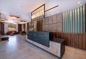 a lobby with a reception desk in a building at Kiani Beach Resort Family All Inclusive in Kalyves +155 photos